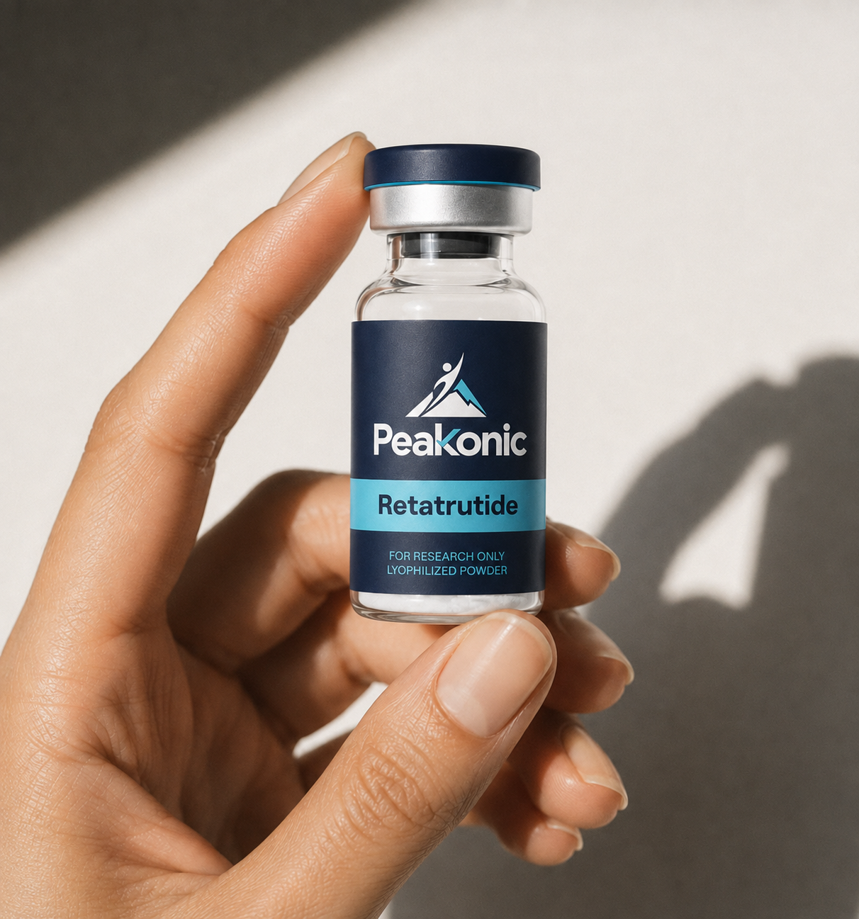 Peakonic Retatrutide research vial held for scale